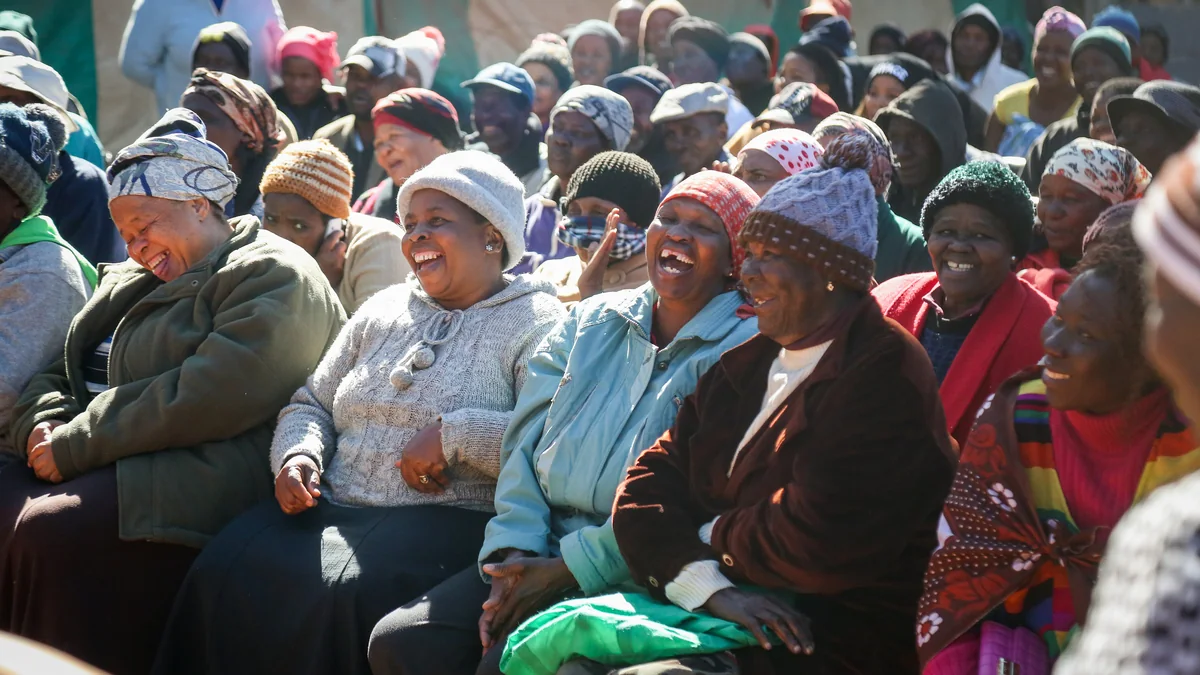 Community members listening and responding during an outdoor stakeholder dialogue session