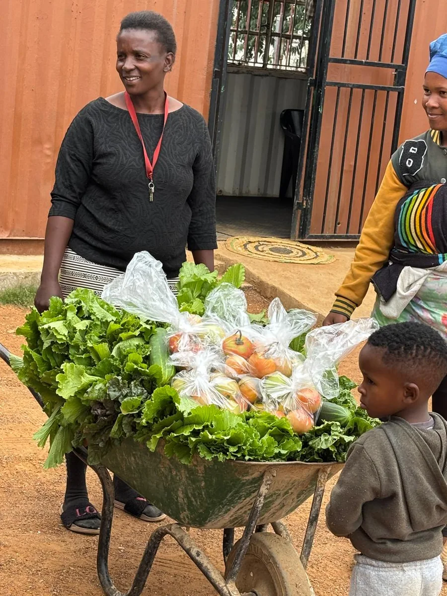 Freshly harvested vegetables from a community food garden being brought to local customers for sale